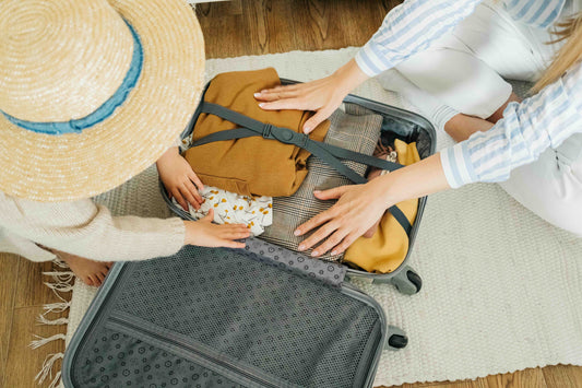 Mom and daughter packing a bag