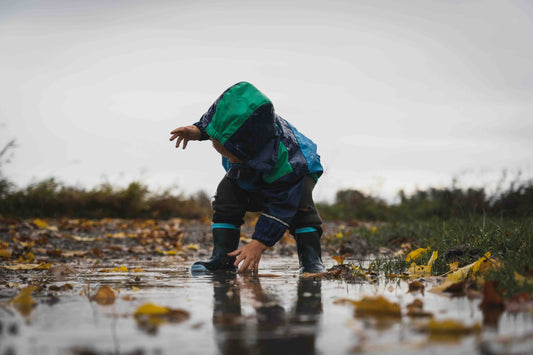 Child playing in the rain