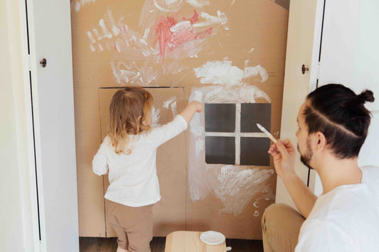 A dad and daughter painting