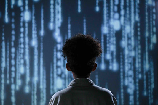 boy looking into large screen