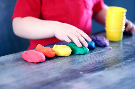 child playing with rainbow sensory dough