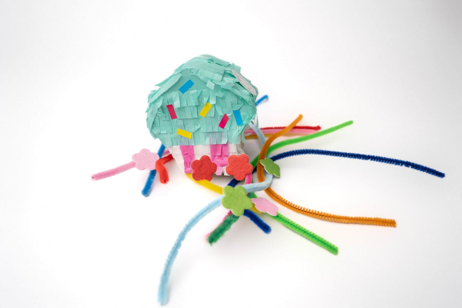 Birthday piñata and rainbow pipe cleaners