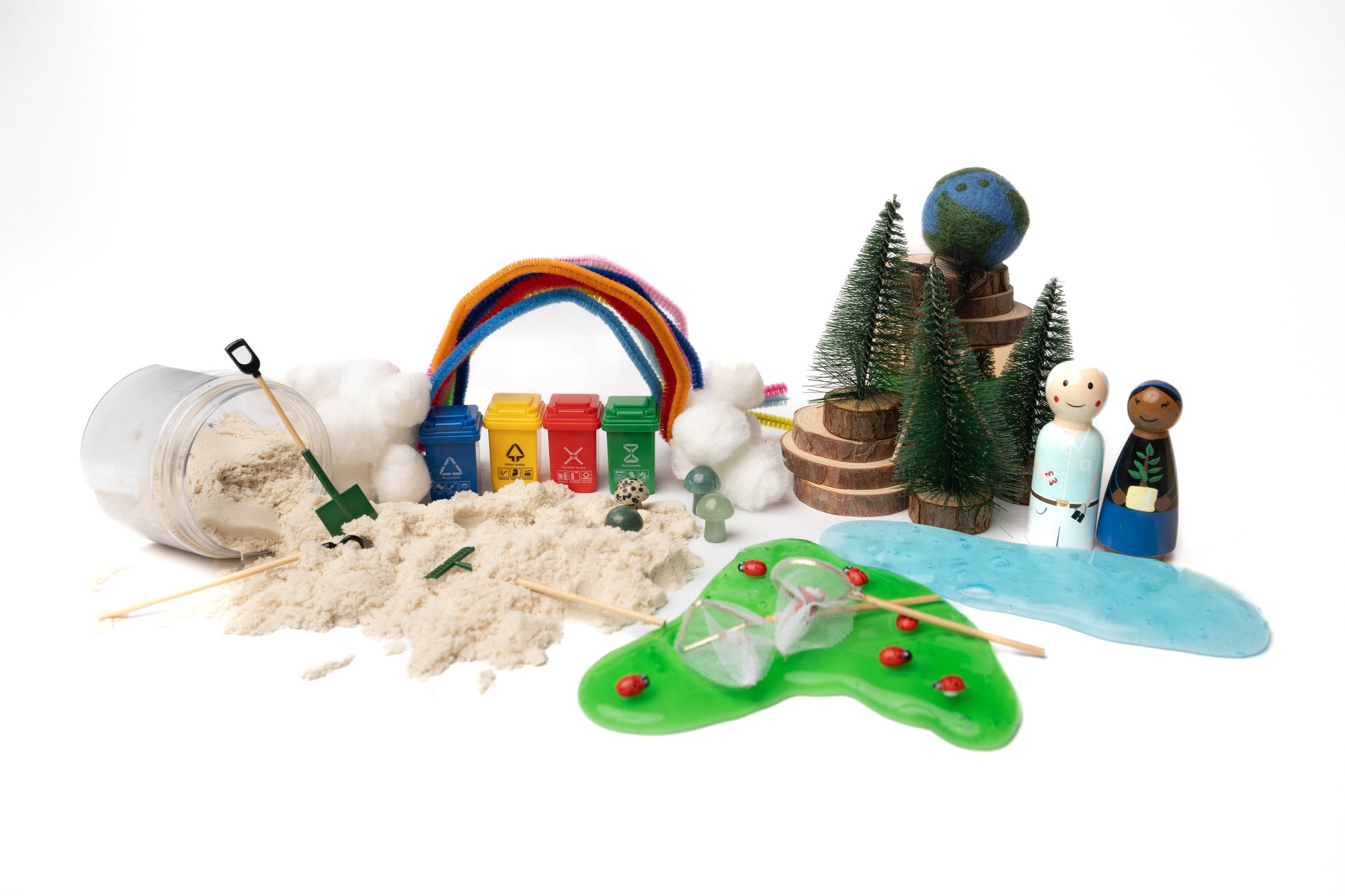 Sensory kit in box showing contents for the planet protector kit including peg dolls, wood rounds, play dough, pipe cleaners, and various mini gardening tools