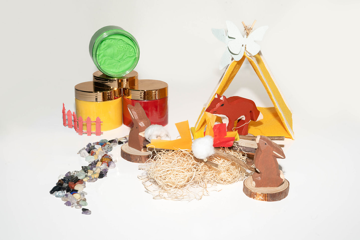 wooden chocolate bunnies roasting marshmallows in a mini woodland adventure scene. Including mini tent, autumn colored play dough and natural river rocks.
