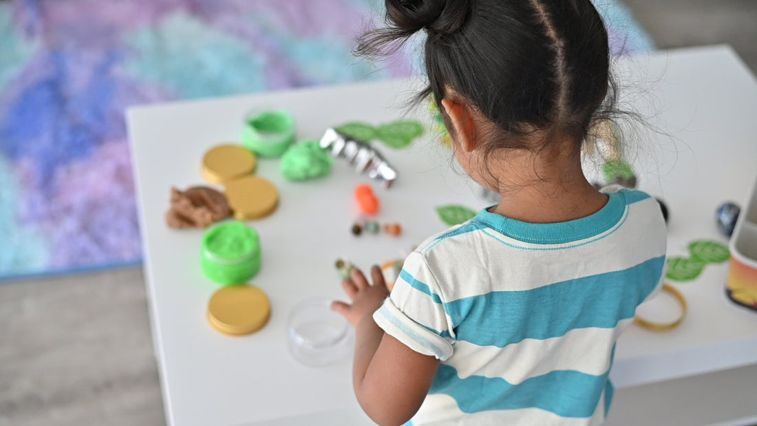 child playing with dinosaur sensory bin