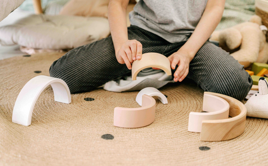 boy playing with sensory toy rainbow