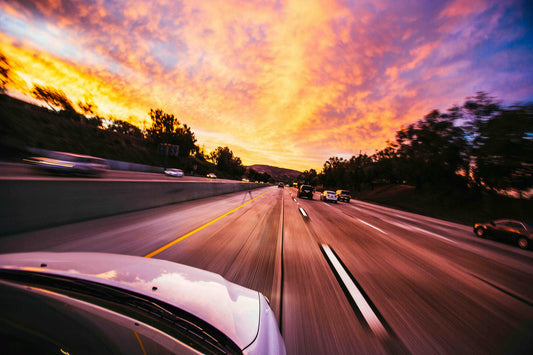 car driving on the highway at sunset