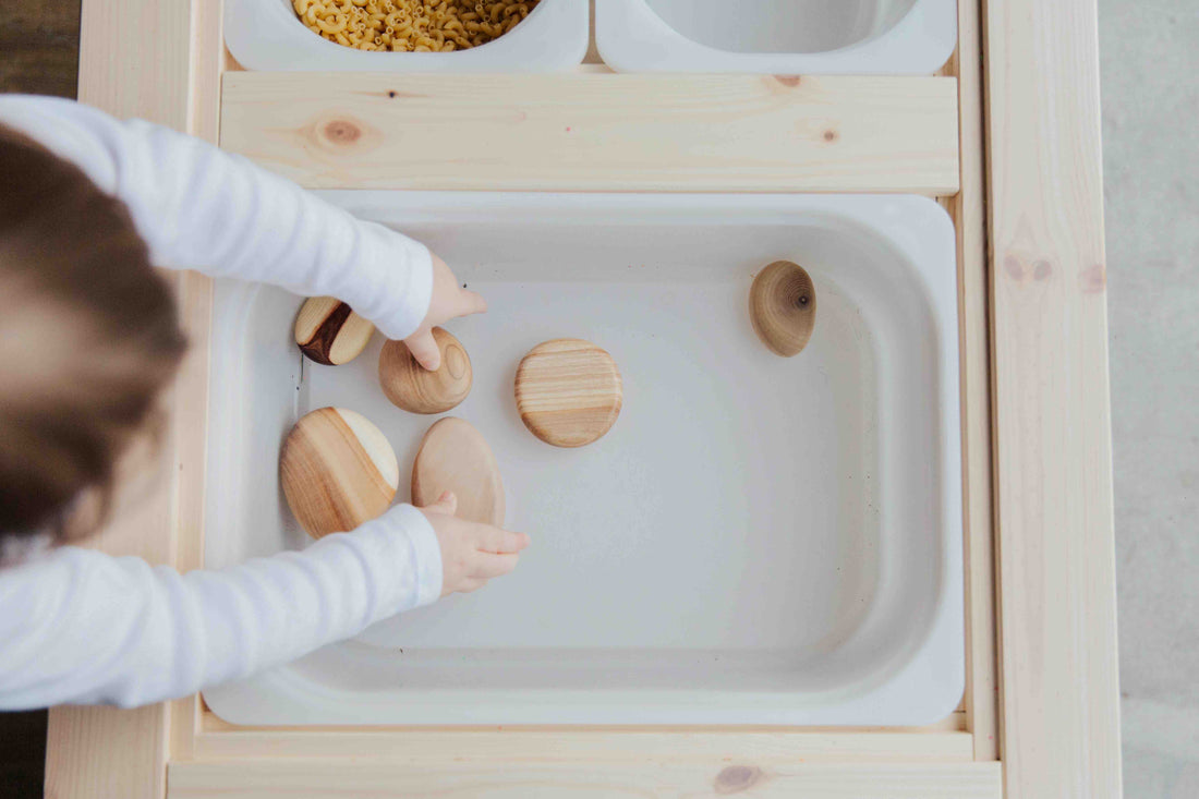 child playing in a sensory bin