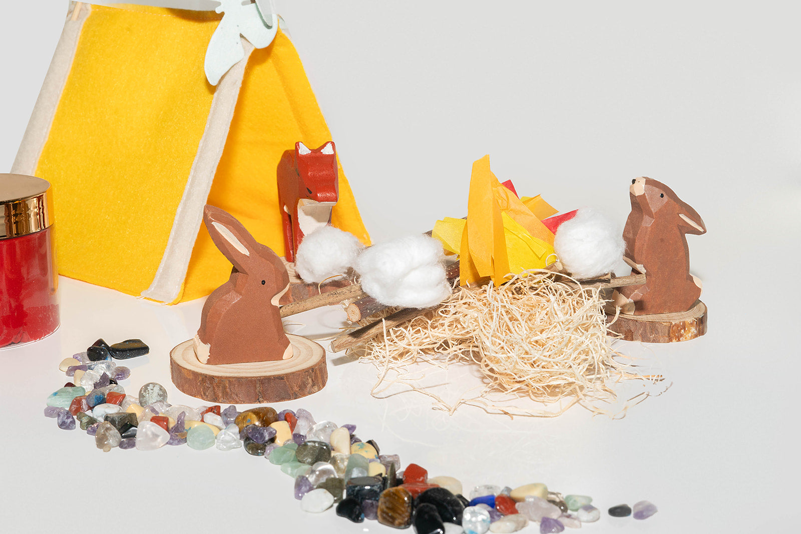 Chocolate bunnies (2) and wooden fox with mini tent in a campfire scene. 