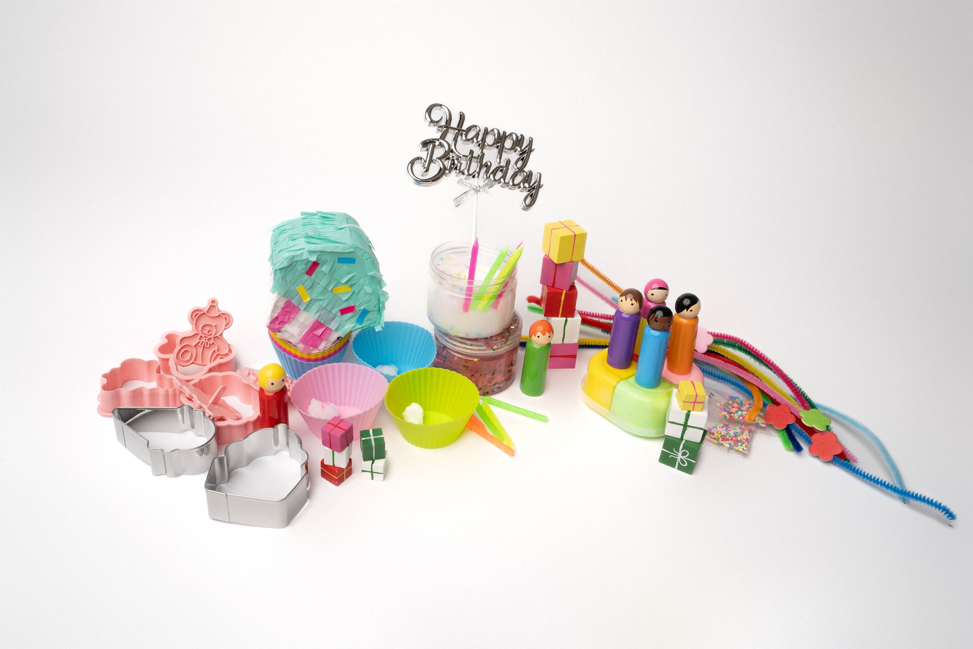 Birthday piñata and rainbow pipe cleaners, peg dolls, cake topper, wooden presents, confetti, rainbow slime, cupcake liners, happy birthday stamps and cookie cutters