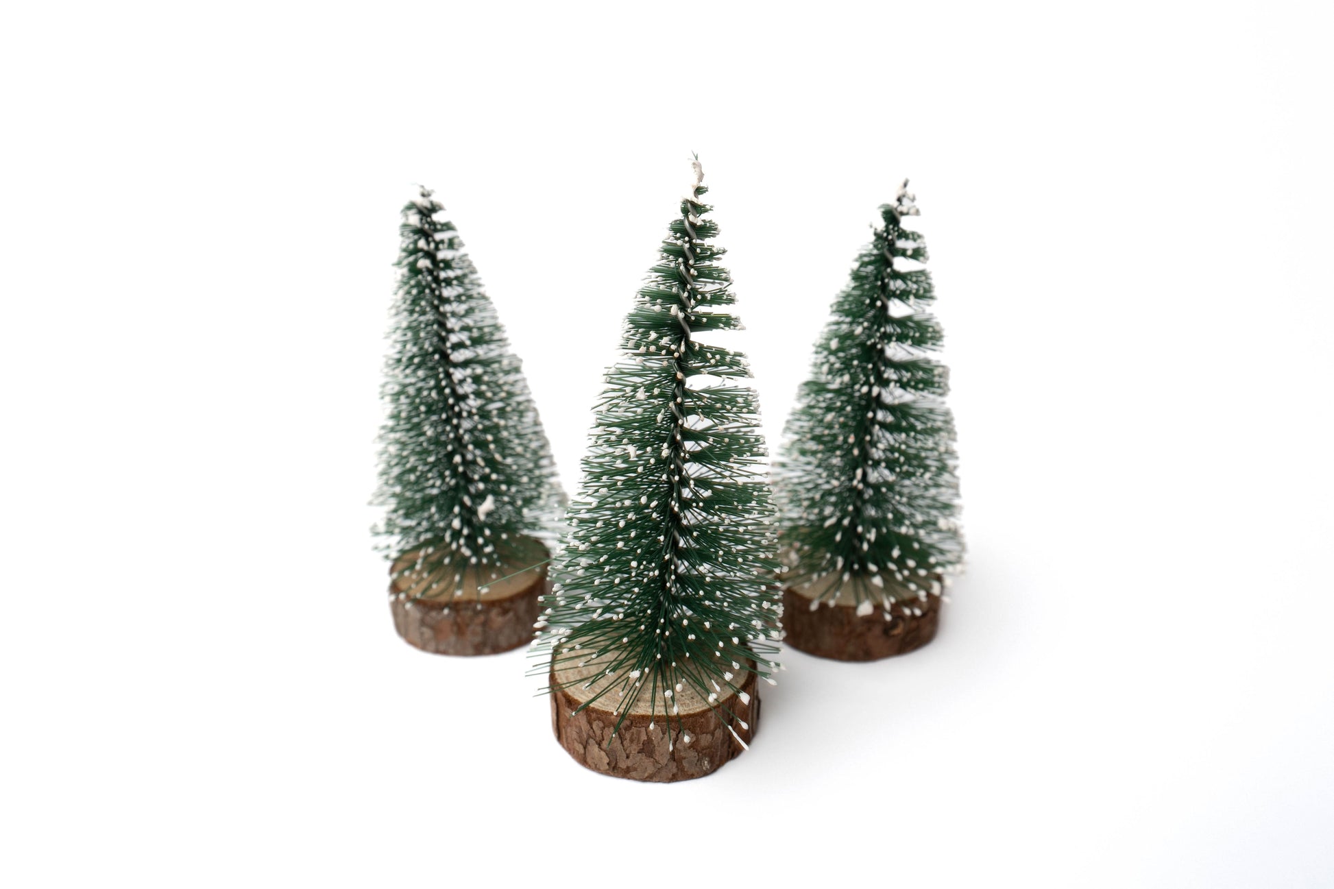 Evergreen pine tree figures with snow dusting