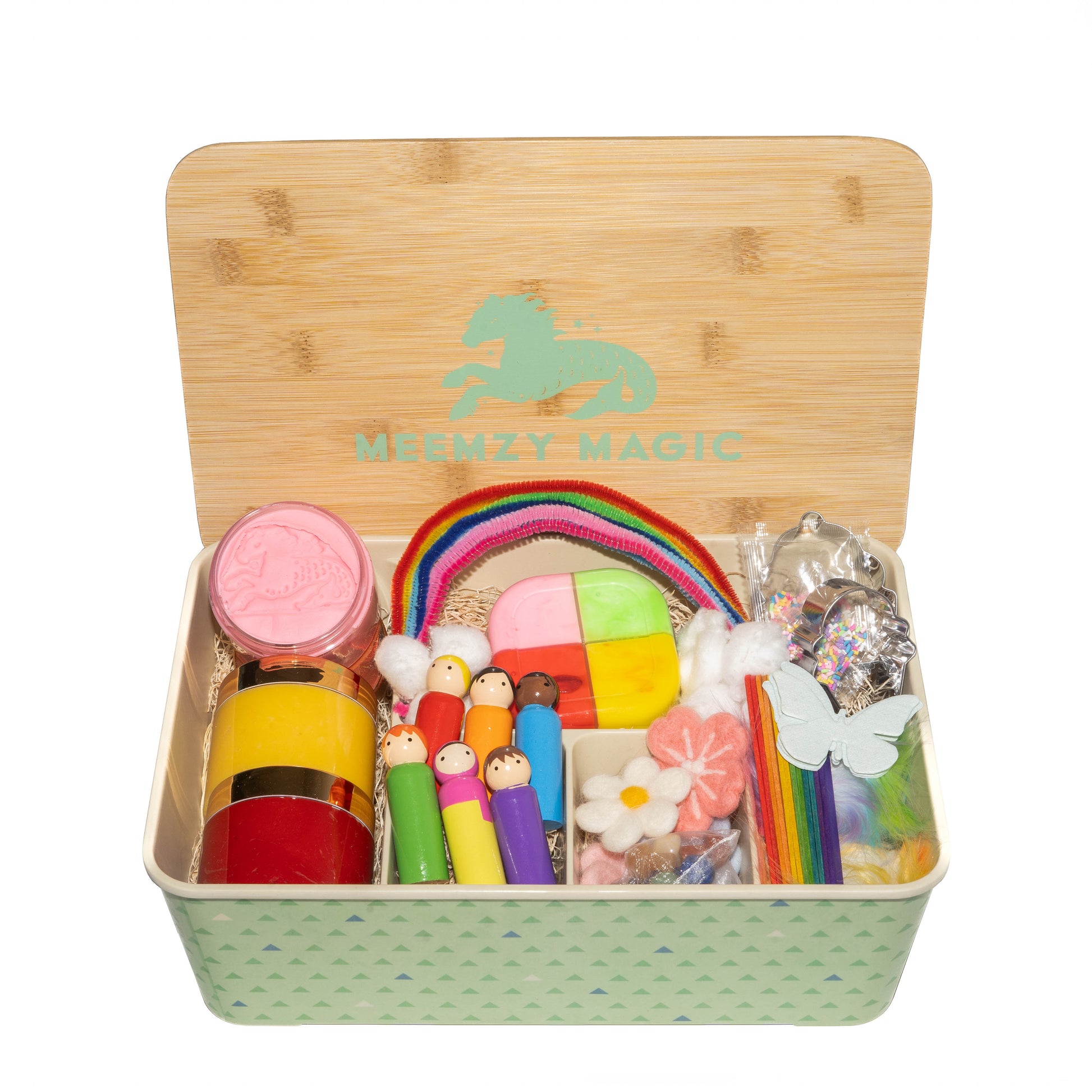 Rainbow Celebration sensory kit in it's box with contents including cotton ball clouds, rainbow pipe cleaners, a variety of colorful play dough, pegs dolls of various colors, and felt flowers and butterflies