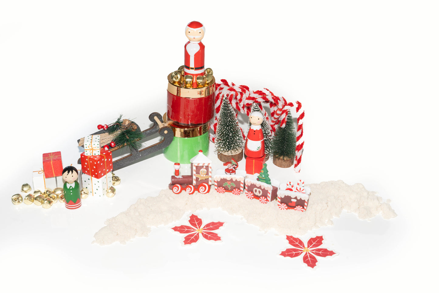 Santa Christmas sensory kit overhead shot showing contents: Santa Claus, Mrs. Claus, bottle brush Christmas trees, elf peg doll, red and green dough, white kinetic sand, jingle bells, wooden blocks for presents and wooden North Pole express train