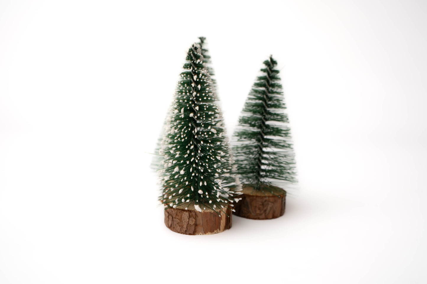 Snow and no snow bottle brush Christmas trees with wood round trunks for evergreen pine trees