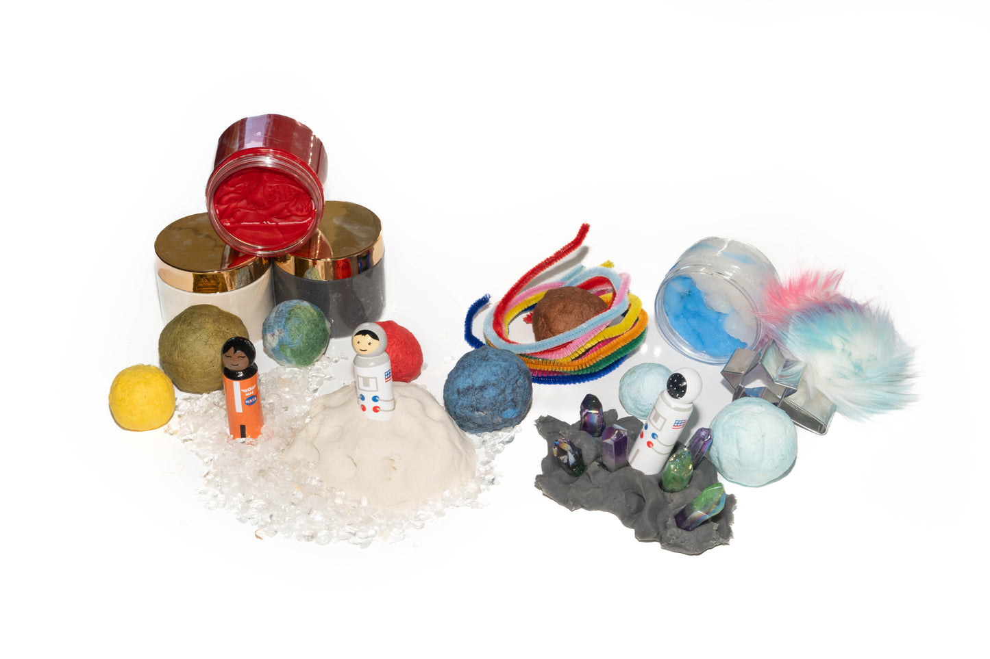 Space sensory kit contents: red and black dough, white kinetic sand, 3 peg doll astronauts hand painted, white crystals, blue and white cloud slime, purple and green ombre crystals, seed bomb planets, star cookie cutter, rainbow pipe cleaners and faux fur rainbow pom pom