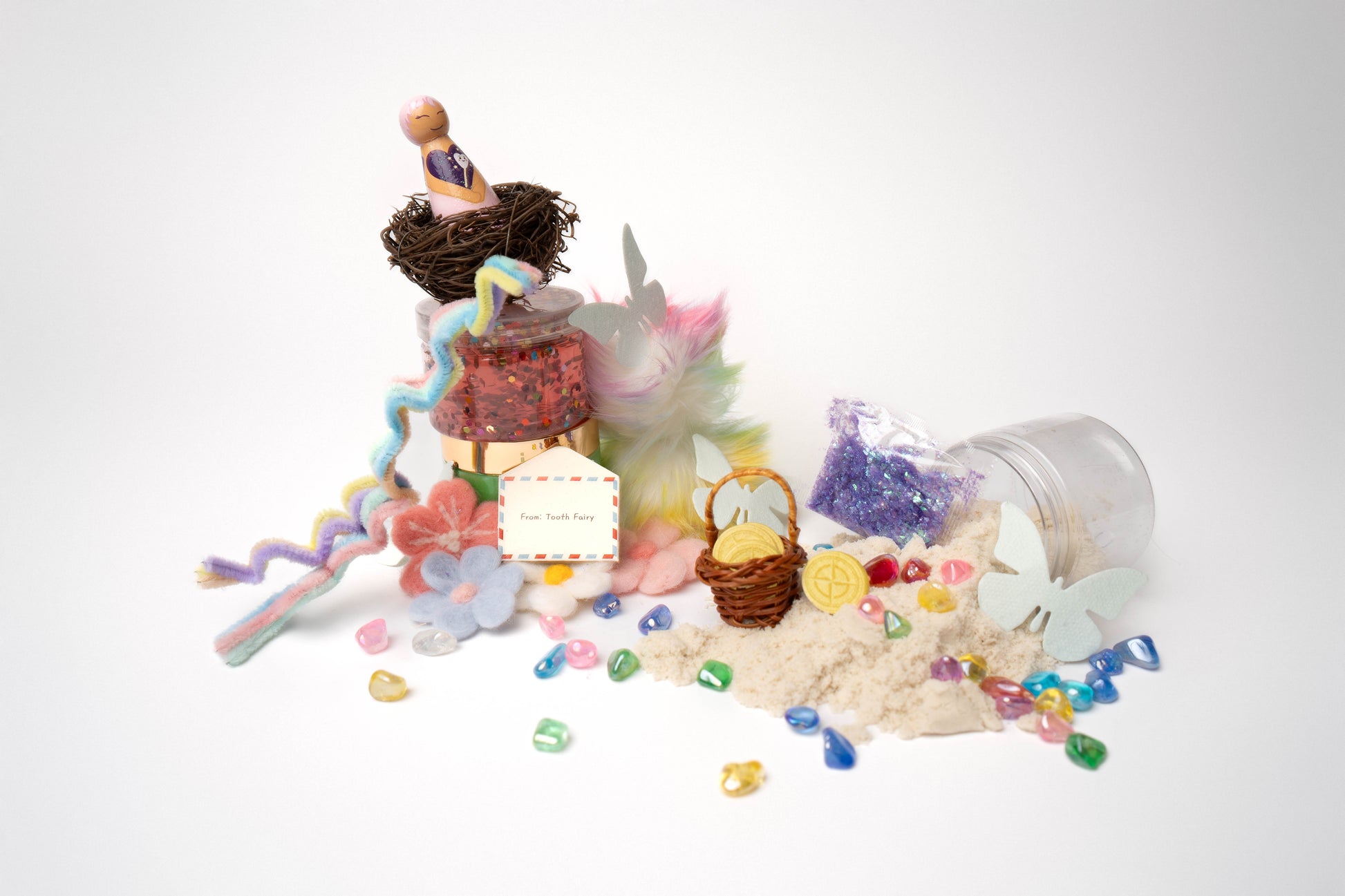 Wooden tooth fairy peg doll, nest, pink slime, green dough, white sand, letter, pompoms, colorful glass stones, purple glitter, felt flowers and pastel pipe cleaners