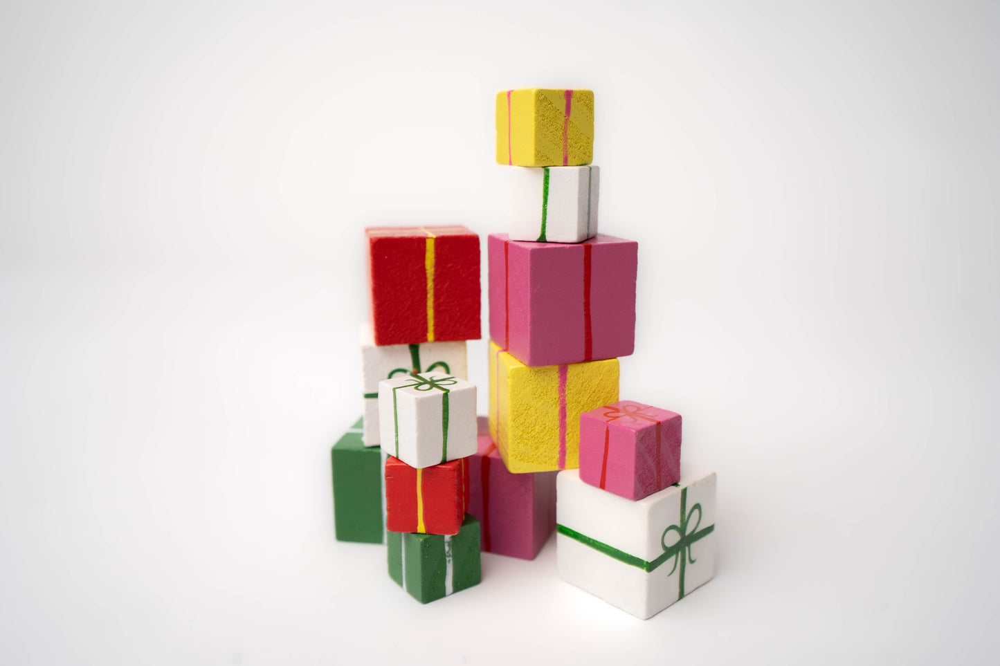 Wooden blocks for birthday presents in pinks, yellow, red, green, white colors