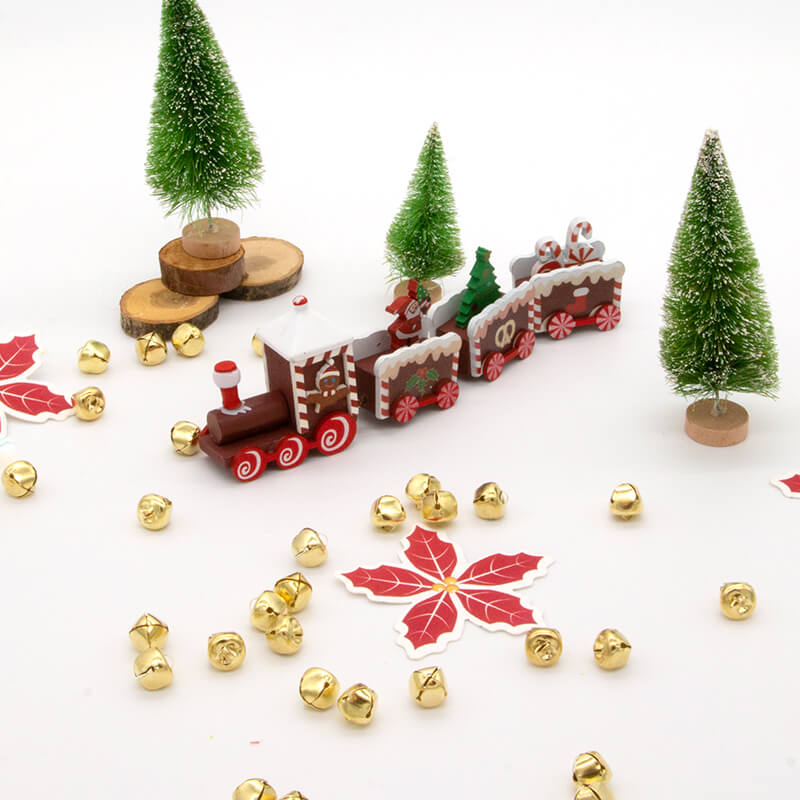 Santa's Workshop kit showing some of the contents including jingle bells, poinsettia shaped wildflower seed paper, a wood train, wood rounds, and small pine trees